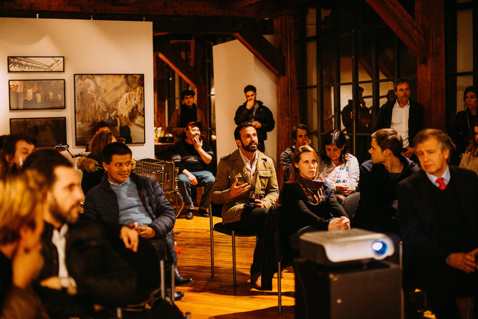 People sitting and watching an event in the violin shop